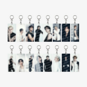 Twelve rectangular acrylic keychains with silver key rings, arranged in two rows of six on a light gray background. Each keychain features a blurred portrait photo of a male idol with repeated 'STAYCUT' watermark text.