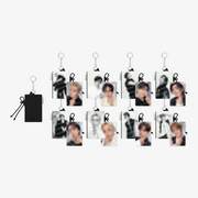 A set of small rectangular photo keychains with metal key rings, shown on a plain light gray background. One black pouch with a drawstring is shown separately on the left, and the keychains feature monochrome and color portrait prints.