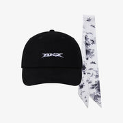 A black baseball cap with a stylized white embroidered logo on the front, displayed next to a white necktie featuring a black ink splash pattern. The items are set against a clean, light gray background.